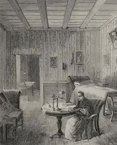 A black and white engraving of a man in robes seated in a high room with wooden walls and simple furnishings.