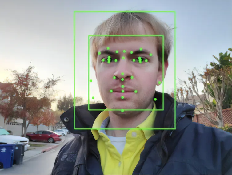 Output of an Artificial Intelligence system from Google Vision, performing Facial Recognition on a photograph of a man, with facial features identified and facial bounding boxes present.