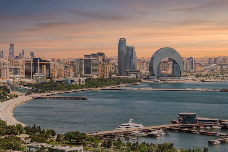 The Crescent Hotel and other urban development in Baku, Azerbaijan, set against sunset on the Caspian Sea coast