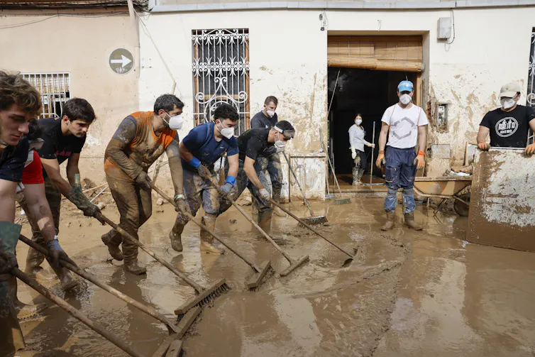 people clean up after floods