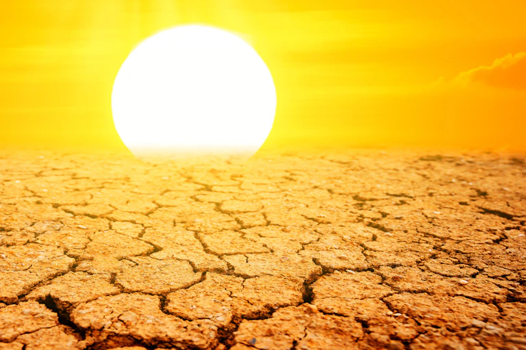 cracked bare ground, white hot sun at horizon, yellow sky