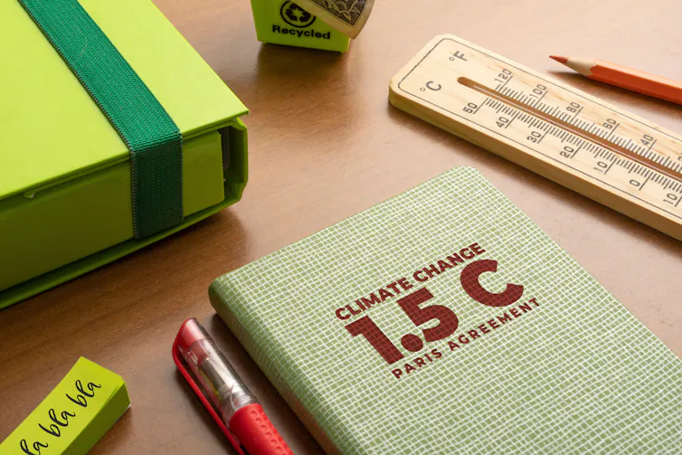 notebook with 1.5 degrees with thermometer and pen on desk