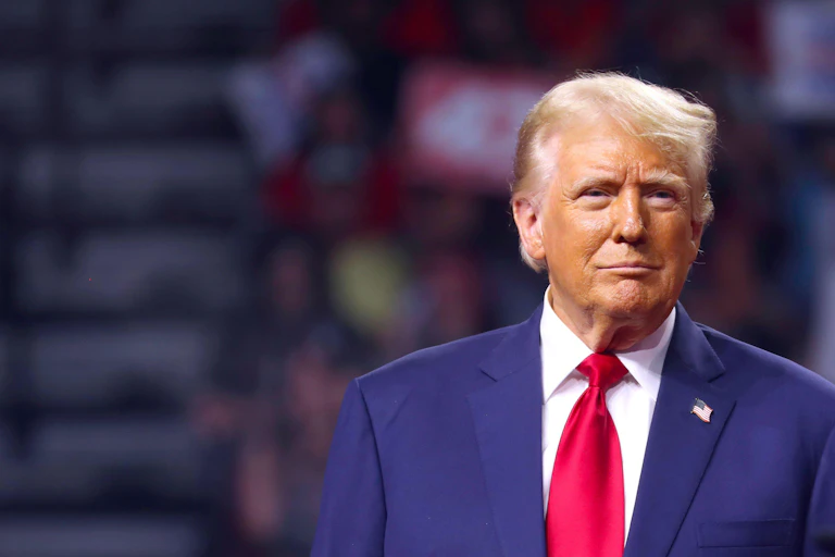 Donald Trump wearing a red tie and blue jacket.