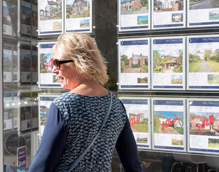 Woman outside an estate agents