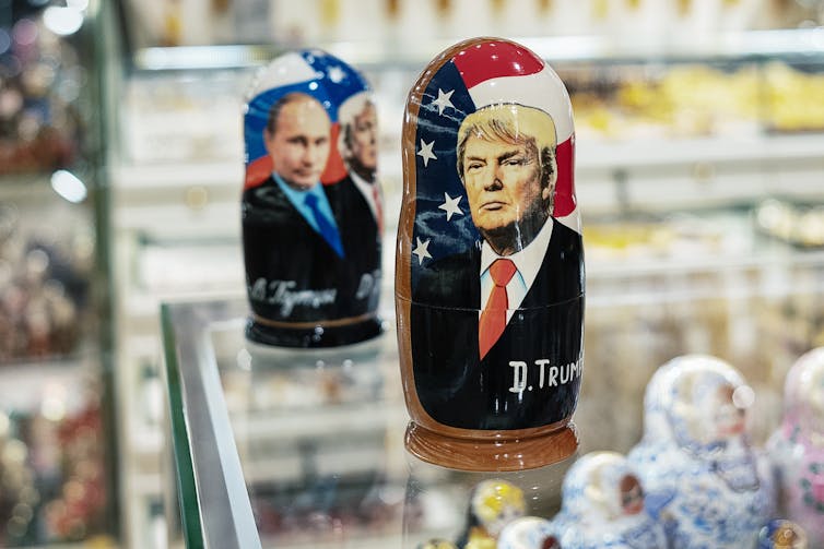 Two Russian dolls are seen, one depicting Donald Trump, the other Vladimir Putin.