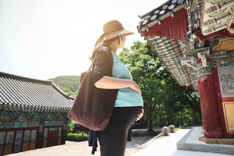 A pregnant woman at a temple.