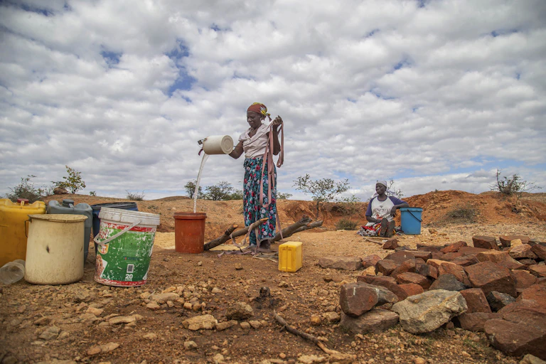 women collecting water, drought