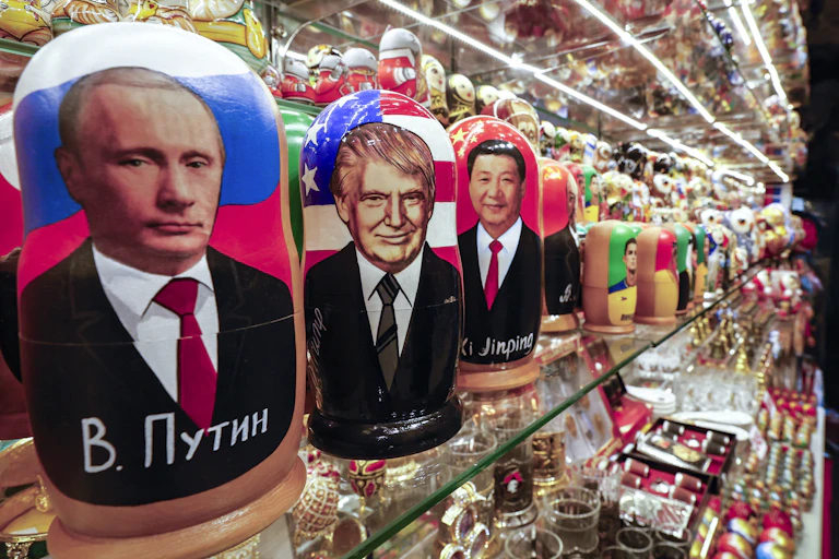 RUssian matrioshka dolls showing Vladnimir Putin, Donald Trump and Xi Jinping.