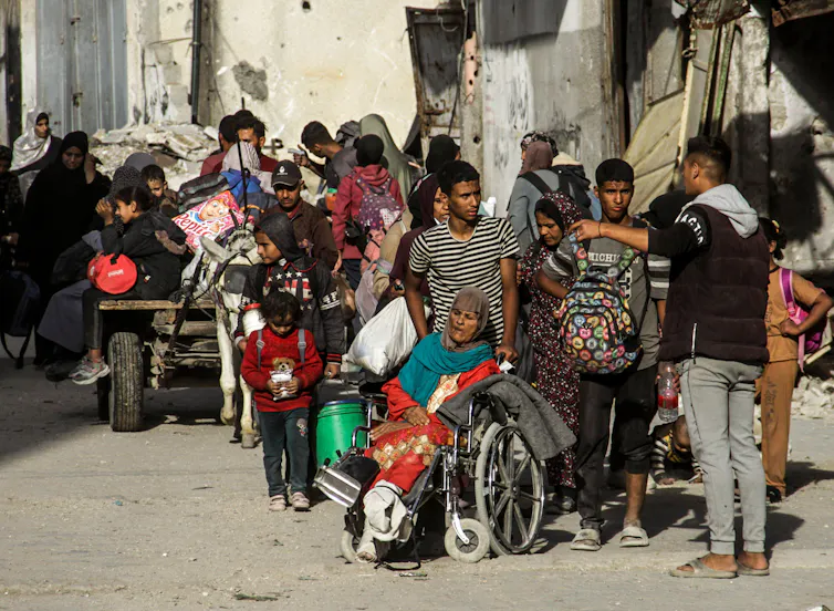 Palestinians leaving a town with all of their belongings.
