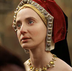 A young woman in regal Tudor dress.