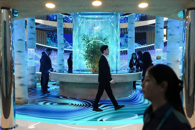 People walk through blue-coloured room