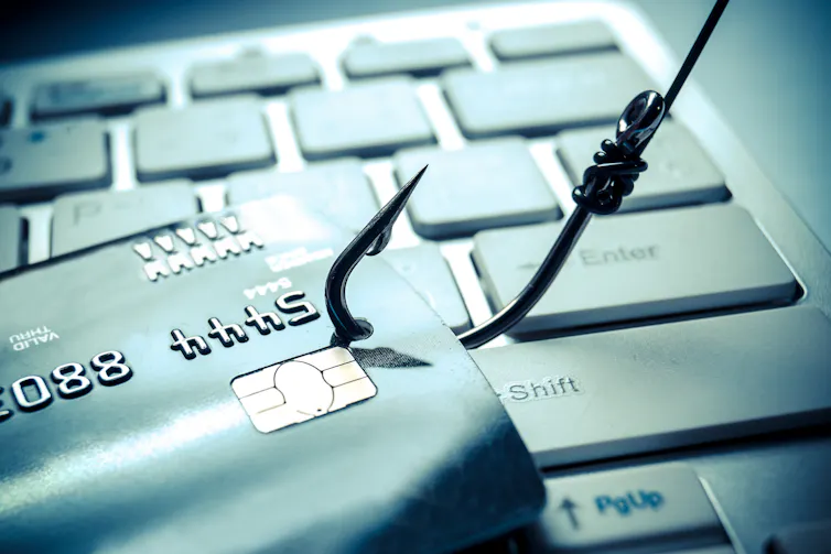 phishing hook with credit card and computer keyboard