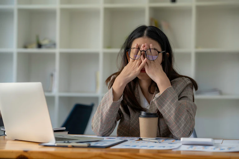 Exasperated person at desk.