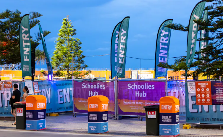 A 'schoolies hub' on the Gold Coast with barricades and signs.