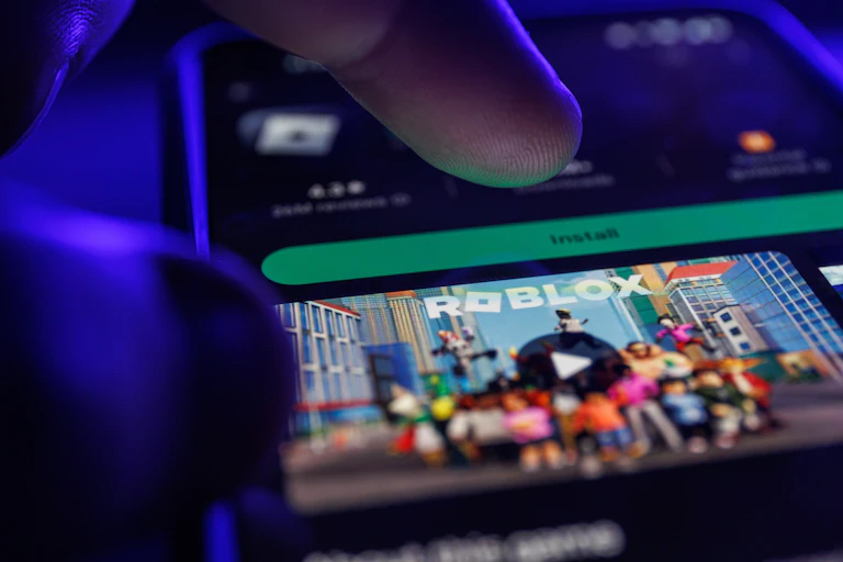 A person installing Roblox on a smartphone.