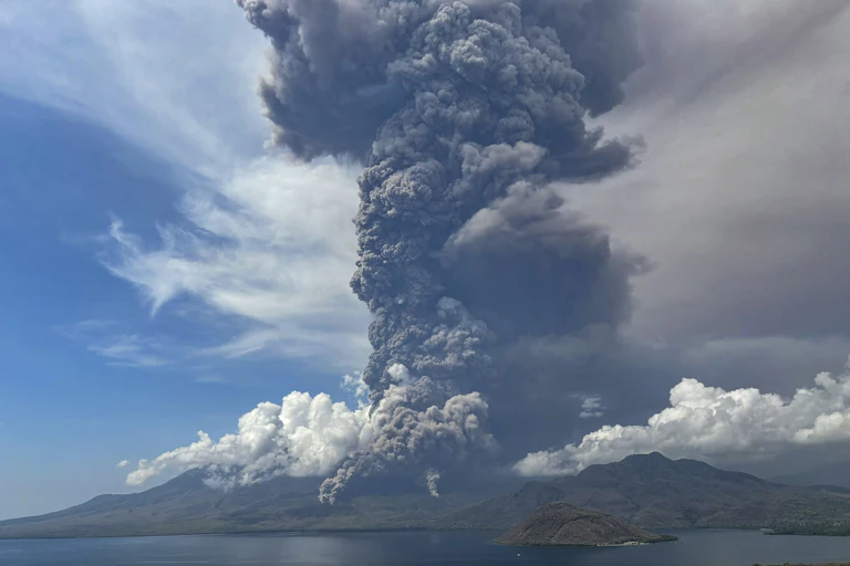 A handout photo made available by the National Board for Disaster Management (BNPB) shows the Lewotobi Laki-Laki volcano spewing volcanic materials during an eruption as seen from Titihena, East Flores, East Nusa Tenggara province, Indonesia.