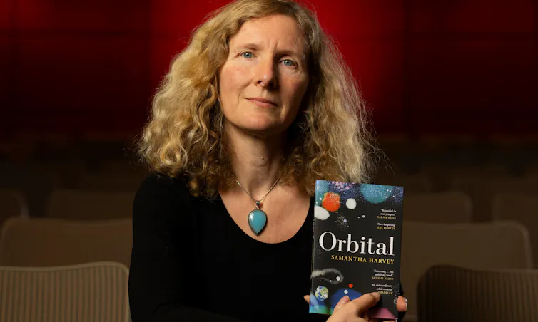Samantha Harvey poses with her book
