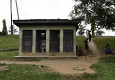 Four run down looking toilets outside