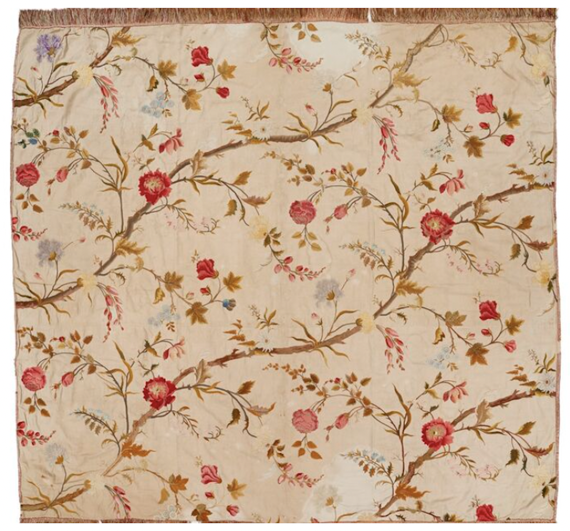 An intricately embroidered 18th-century bedcover of red flowers on a beige background.