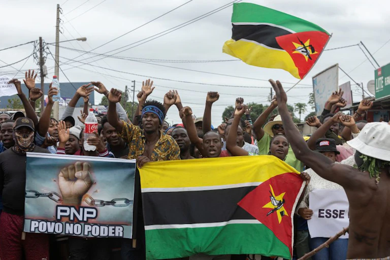 People holding flags and posters in the street