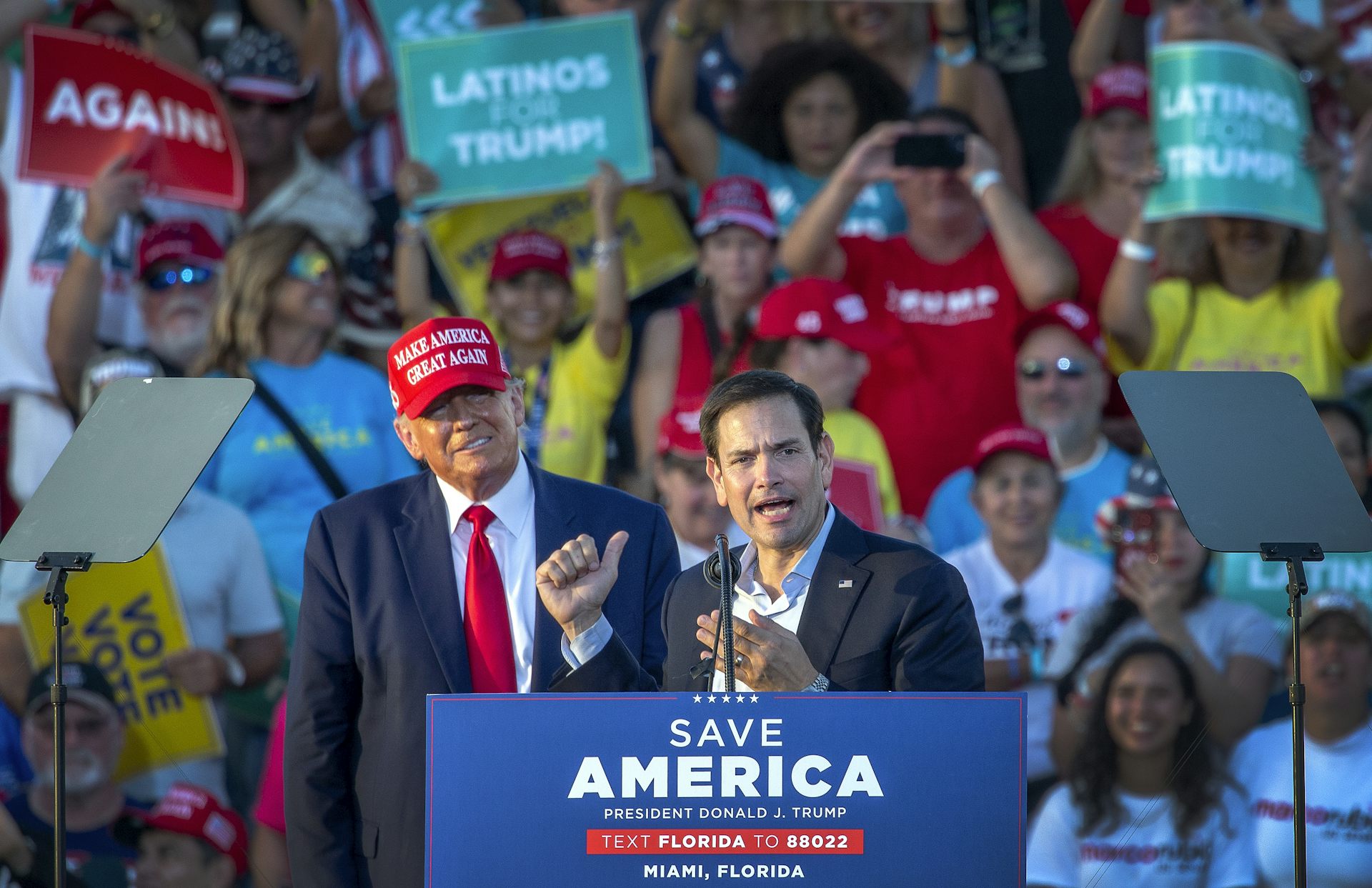 Donald Trump tands behind Republican senator Marco Rubio as Rubio speaks a t a campaignrally 2022.