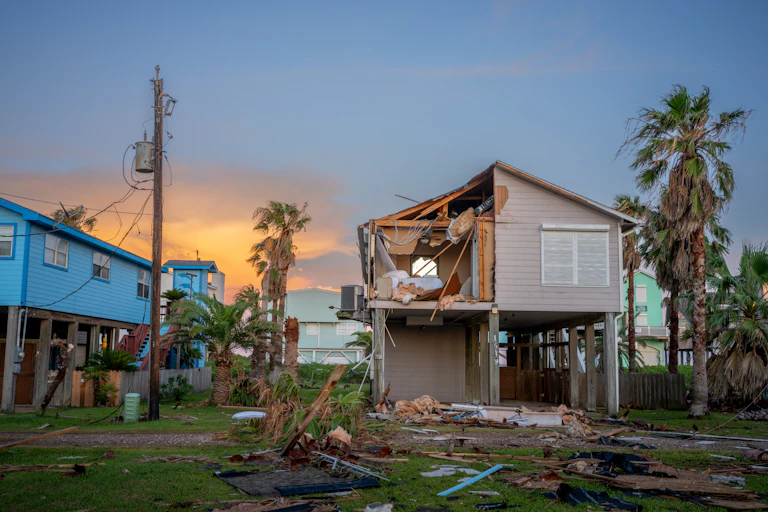 A house built on stilts is still damaged from high winds.