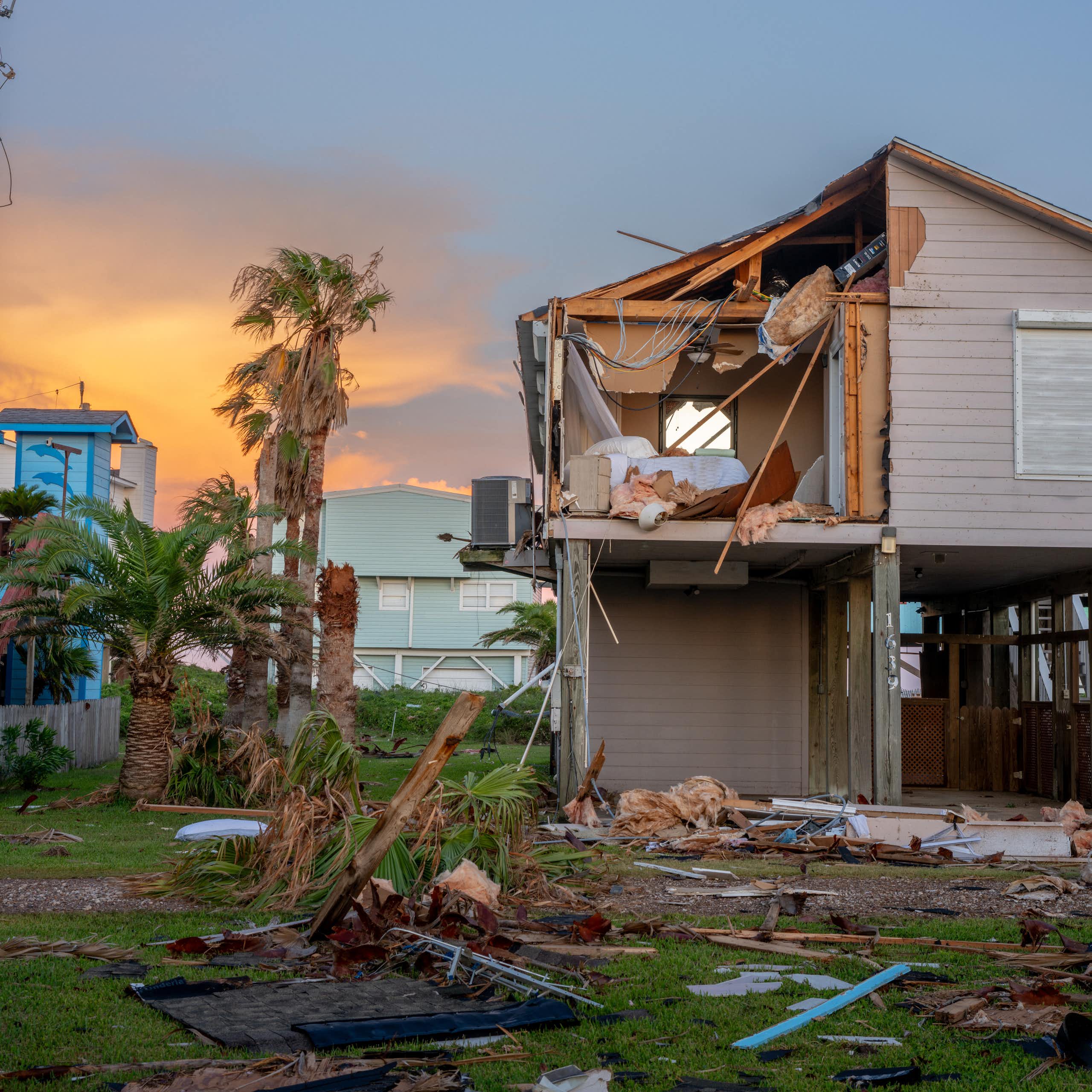 A house built on stilts is still damaged from high winds.