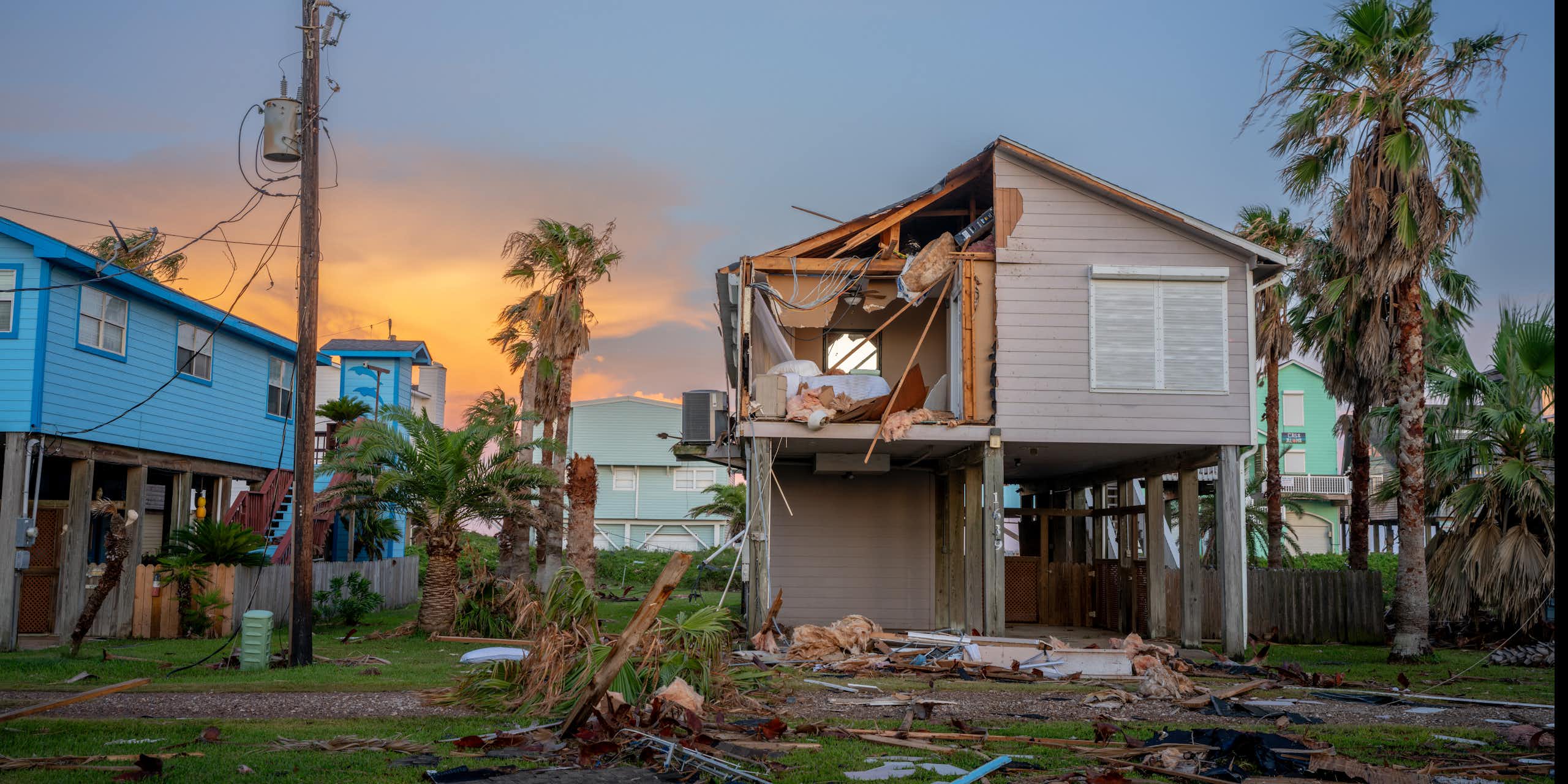 A house built on stilts is still damaged from high winds.