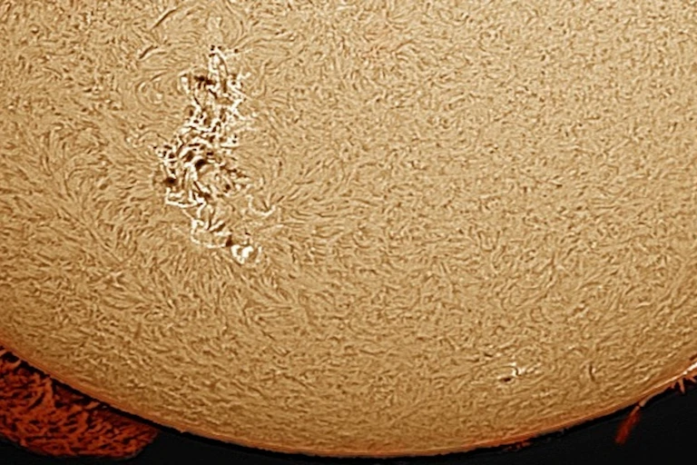 a large pale yellow sphere covered in swirls around a brighter section