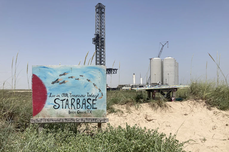 A painting showing a fleet of rockets soaring through the sky and the words 'Live in our tomorrow today! Starbase, Boca Chica, TX' in front of a SpaceX launch site.