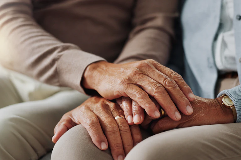 Close up of a senior couple holding hands