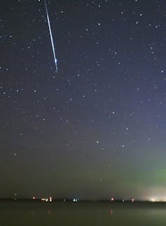 A fireball appears in the night sky.