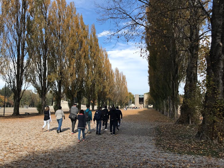 People seen walking on a path.