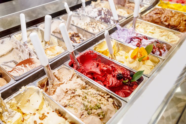 Rows of gelato tubs in a display cabinet