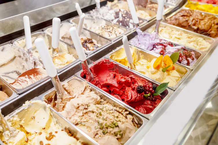 Rows of gelato tubs in a display cabinet