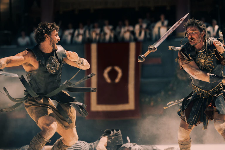 Two gladiators fighting in the Colosseum dressed in leather armour.