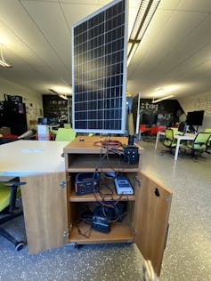 A solar panel standing upright on a table.