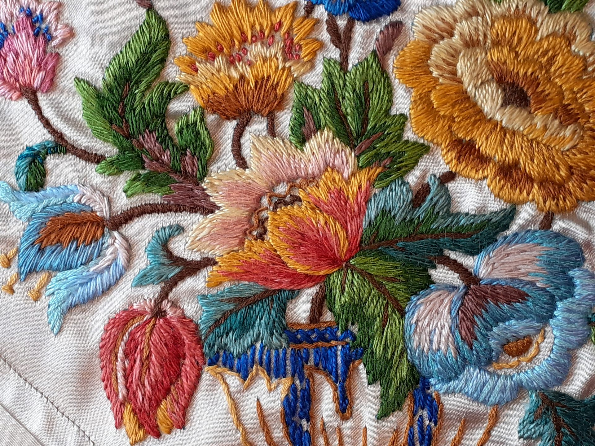 A table runnerl embroidered with beautiful flowers.