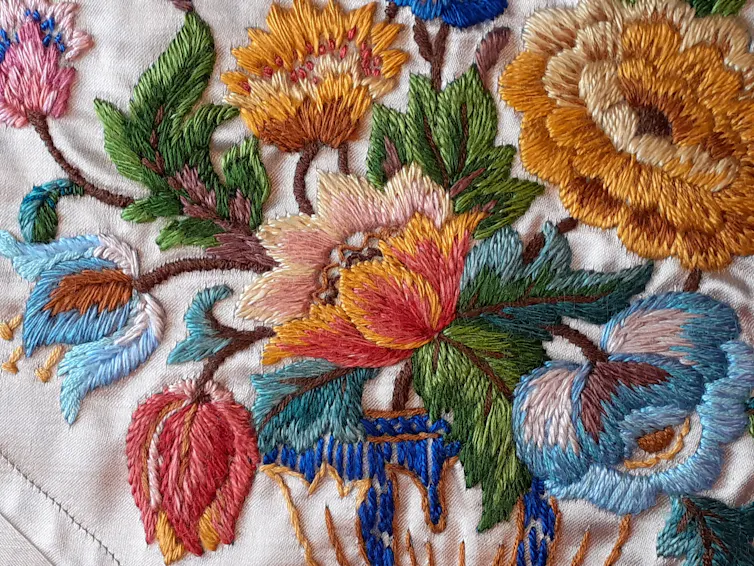 A table runnerl embroidered with beautiful flowers.