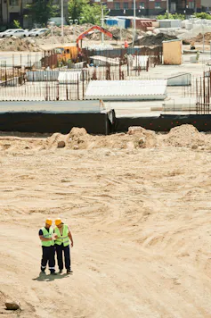 Aerial view of two workers on a construction site