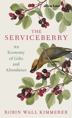 Book cover, The Serviceberry by Robin Wall Kimmerer, font in red, beige cover with red purple berries and green leaves