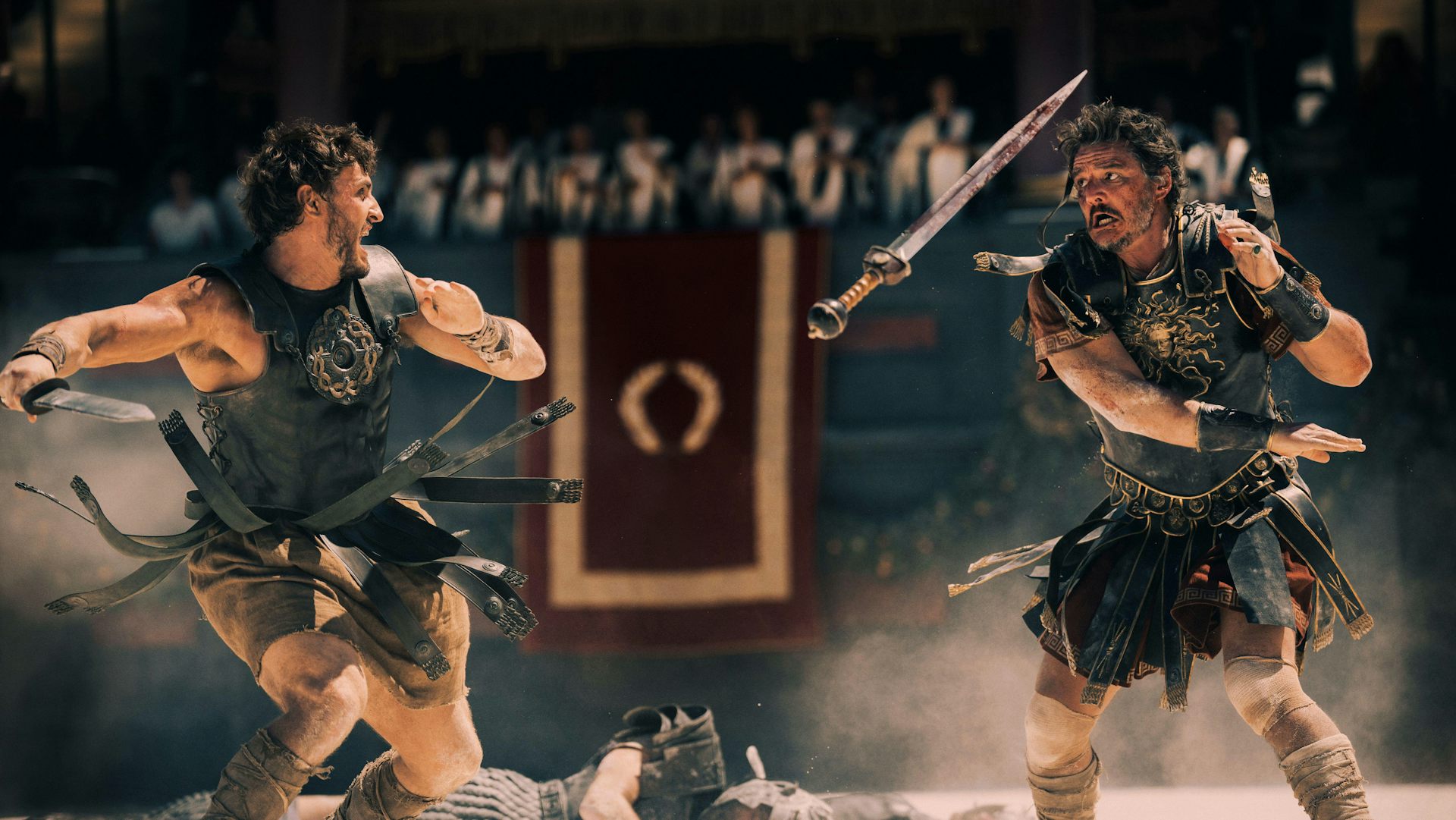 Two roman gladiators in leather armour fighting in the Colosseum.