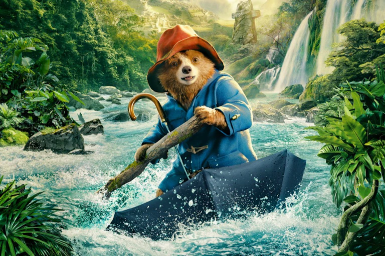 Paddington on an umbrella going down a river.
