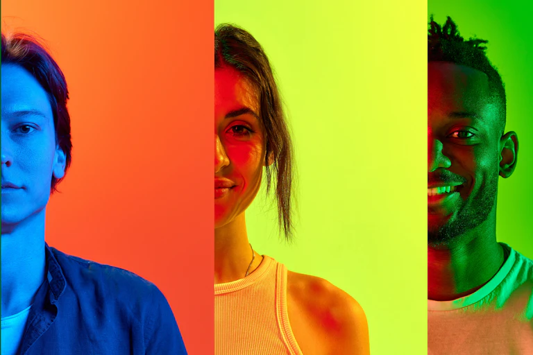 A row of people against multicoloured backgrounds
