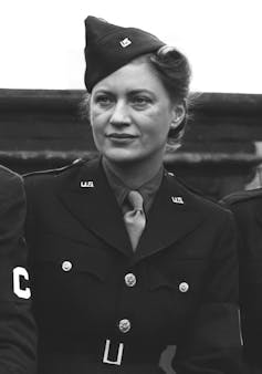 A black and white photo of a woman in military uniform.