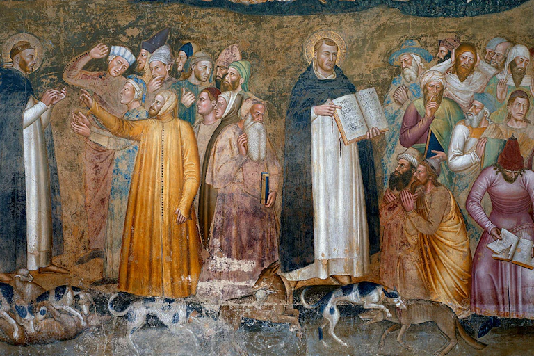Two men in monk's robes stand a few feet apart, each one talking with a crowd of men in colorful robes.