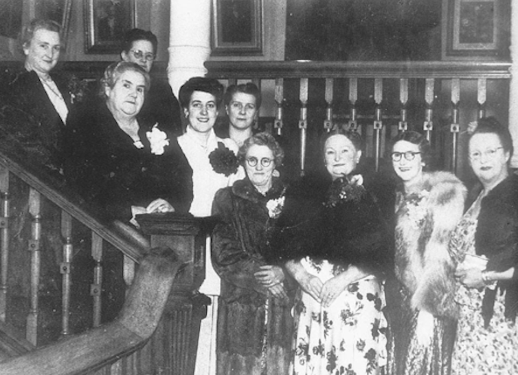A black and white photo of a group of women publicans in 1948.