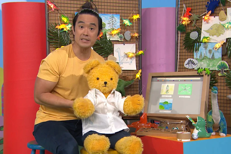 Still image from Play School showing Big Ted using the internet