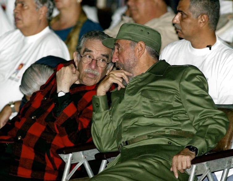 Two men talking at a political meeting.