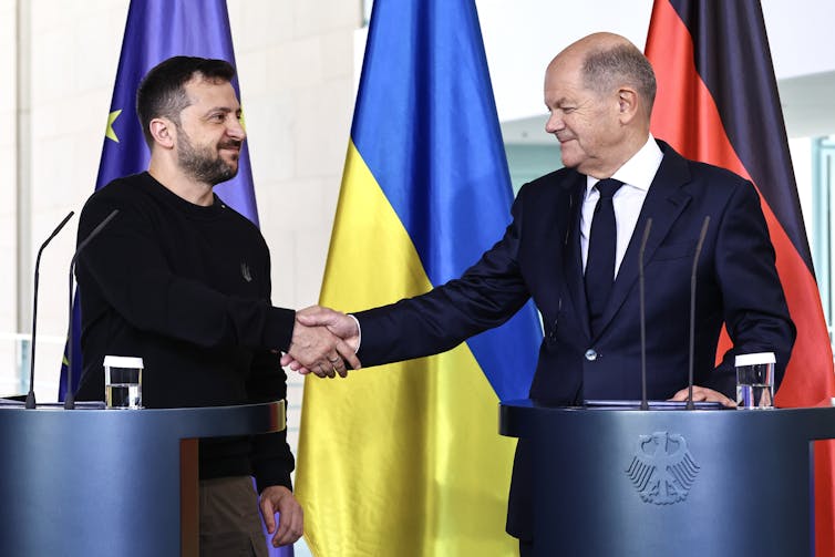 Olaf Scholz and Volodymyr Zelensky shaking hands.